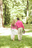 couple walking through park for baby book